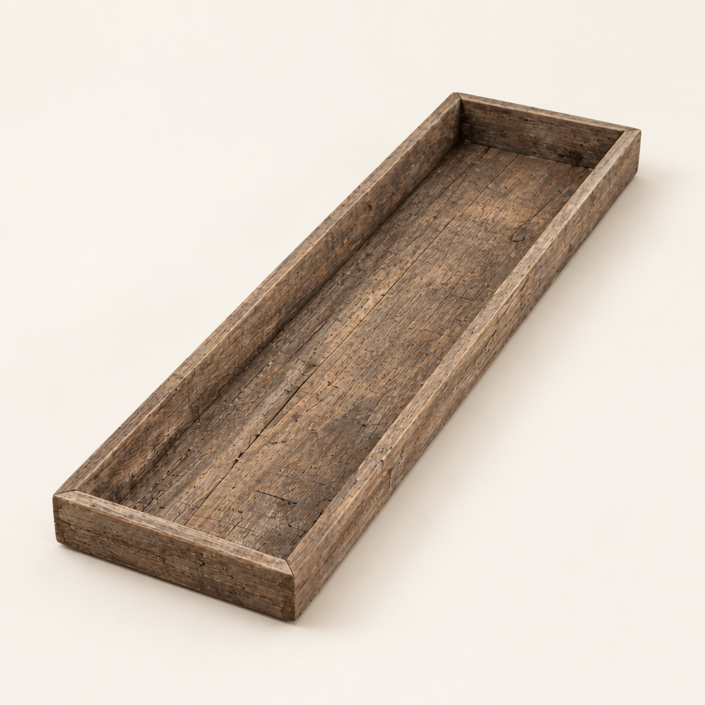 Empty long rectangular weathered wood tray on an ivory background