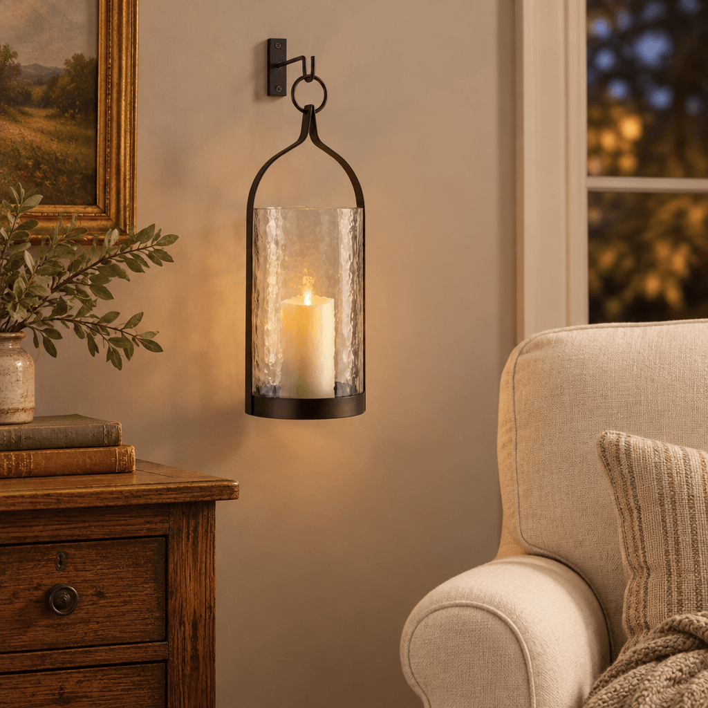 Hammered glass and iron lantern hanging beside a linen armchair with a glowing LED flameless candle