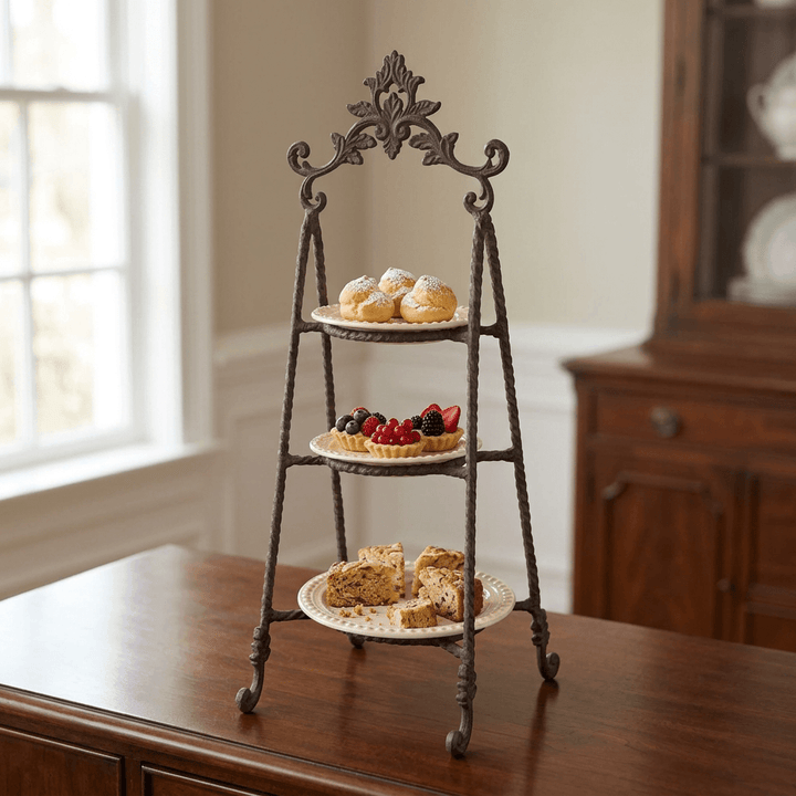 Bellavita three-tier serving stand displaying cream puffs, berry tartlets and cake slices on its three cream plates