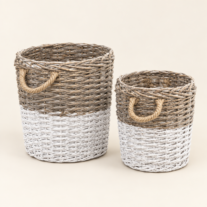 Two White-Dipped Willow Baskets with rope handles on an ivory background