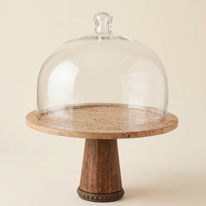 Maribel marble cake stand with glass dome on an ivory studio background.