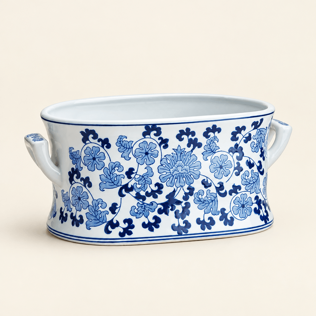 Blue and white floral porcelain lotus planter with side handles on an ivory studio background