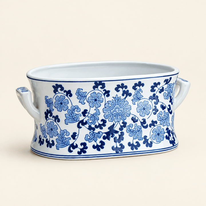 Blue and white floral porcelain lotus planter with side handles on an ivory studio background