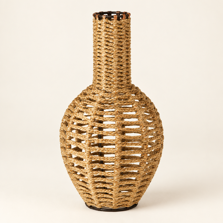 Handwoven jute vase with a rounded openwork body and narrow neck on an ivory studio background.