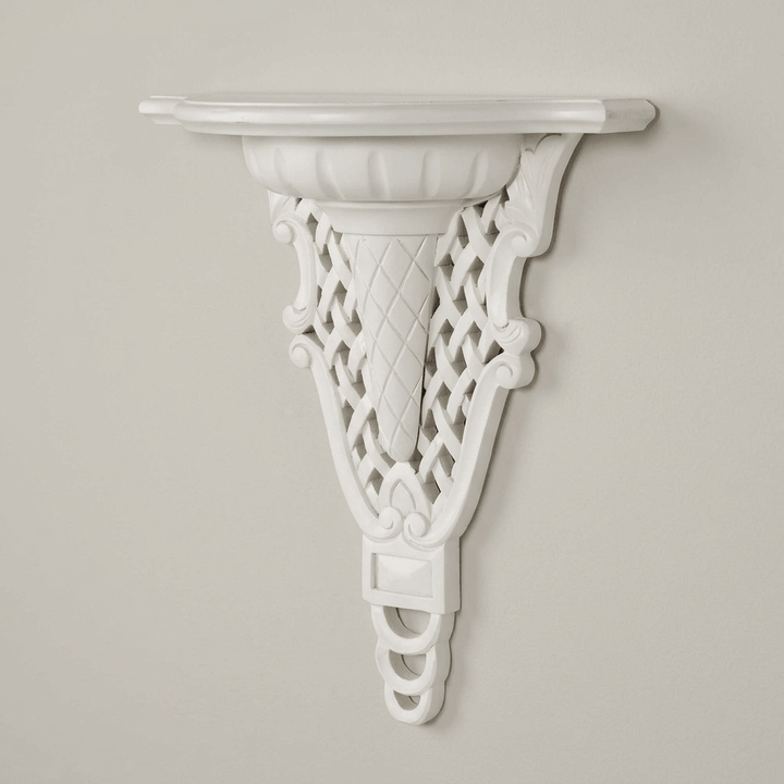 Angled view of white Avelisse Wall Ledge highlighting the curved display surface and carved support.