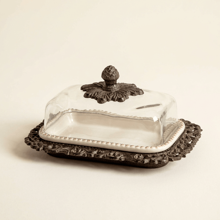Bellavita butter dish with cream ceramic insert, glass dome and dark acanthus base on an ivory background