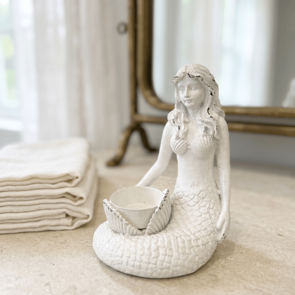 White mermaid candle holder styled on a vintage coastal vanity
