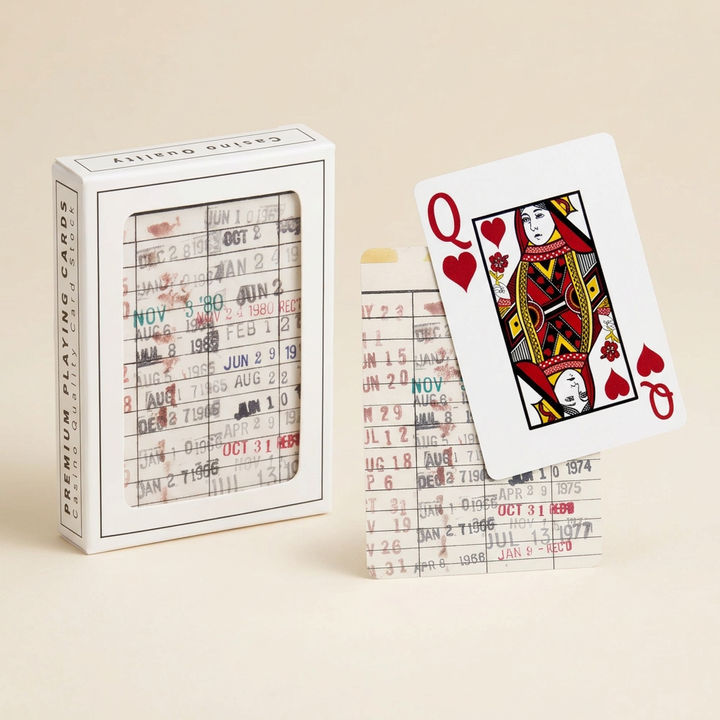 Library due date playing cards with vintage stamp artwork, queen of hearts, and white window box on an ivory background