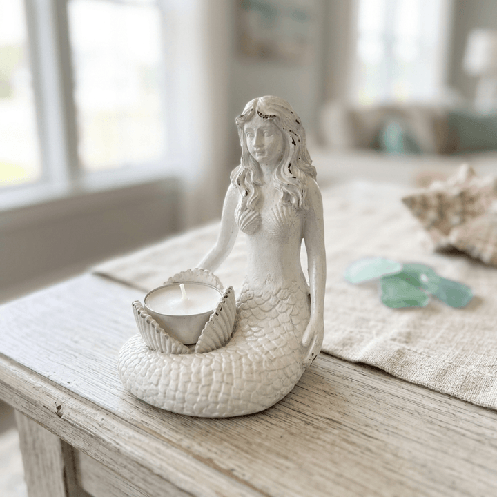 White mermaid candle holder styled on a coastal cottage console