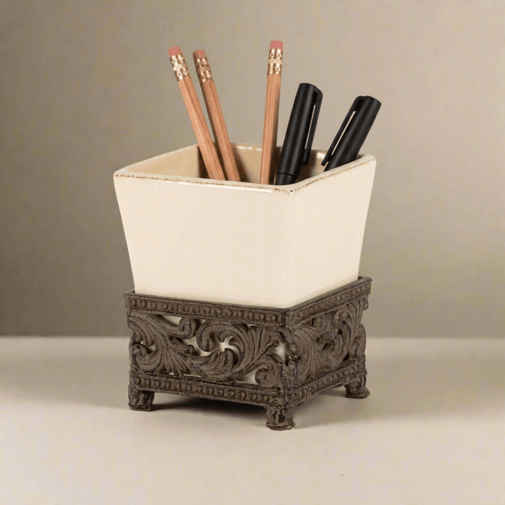 Bellavita cream ceramic pen and pencil holder with ornate dark-metal base styled with wood pencils and black pens