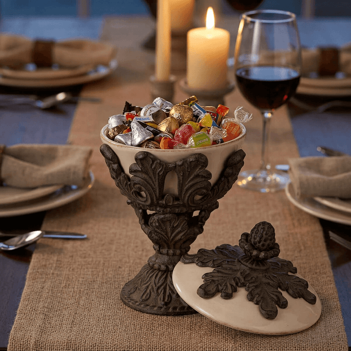 Bellavita Stoneware Lidded Nut Bowl filled with wrapped candies on a linen-runnered dining table set with wine and candles