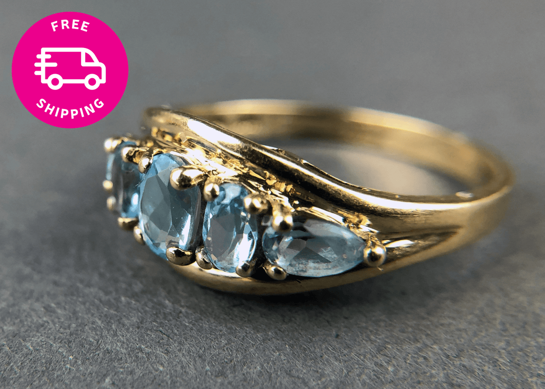 Vintage 10k Gold Ring with 5 Blue Topaz Stones in yellow gold, showcasing five beautiful blue topaz gems.