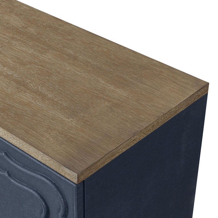 Close-up of the warm wood-toned top above the blue textured cabinet.