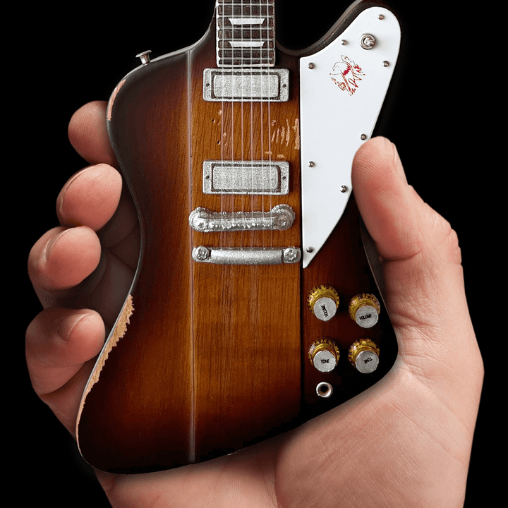 Johnny Winter 1963 Firebird Mini Guitar Replica being held in hand, showcasing intricate design details.