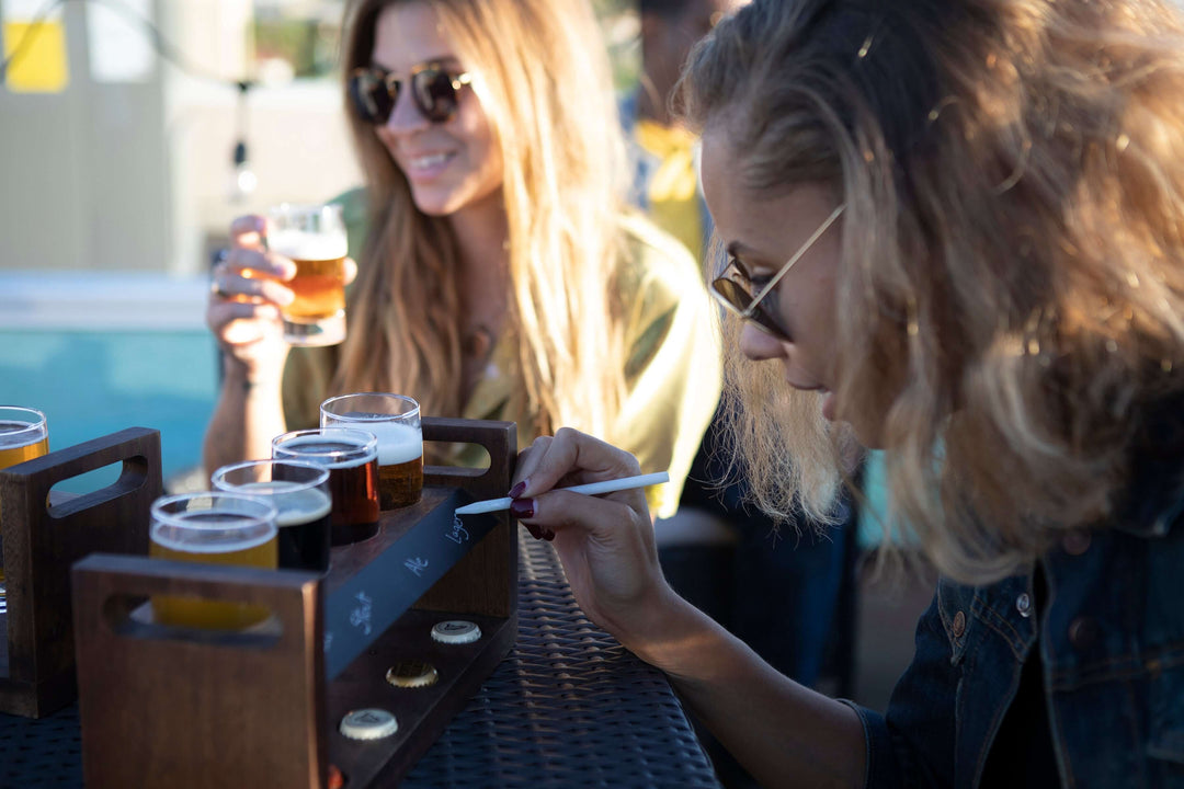Women enjoying drinks with a Rustic Craft Beer Flight Tasting Set on an outdoor patio table.