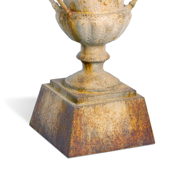 Close-up of Large Rustic Metal Garden Urn with Aged Patina Finish showcasing its weathered base and intricate design.