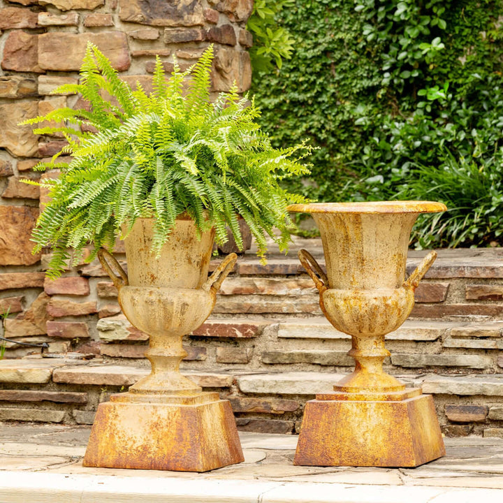 Large Rustic Metal Garden Urn with Aged Patina Finish, showcasing a classic design in an outdoor setting with a lush fern decoration