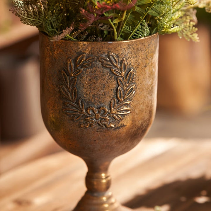 Laurel Wreath Gold Urn Planter styled in a warm botanical vignette