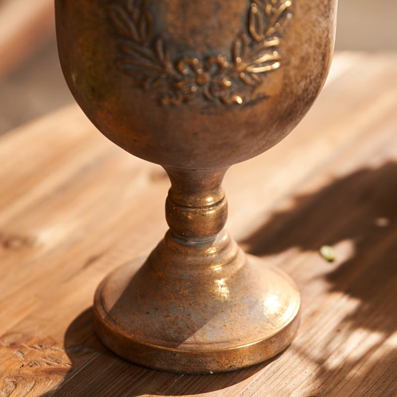Close view of the embossed laurel wreath and antique gold finish