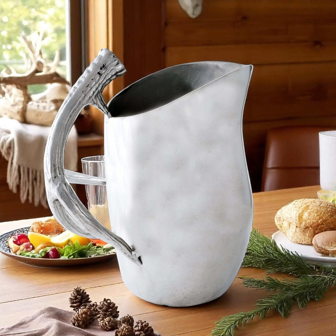 Lodge Style Antler Pitcher on rustic wooden table with fruit and pastries