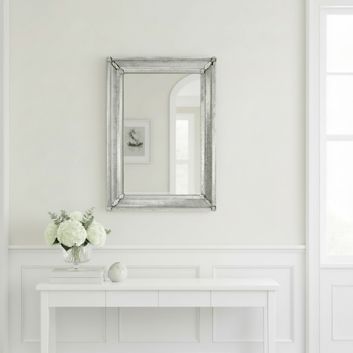 Murano Antique Glass Venetian Wall Mirror reflecting a minimalistic interior with white flowers and soft lighting.
