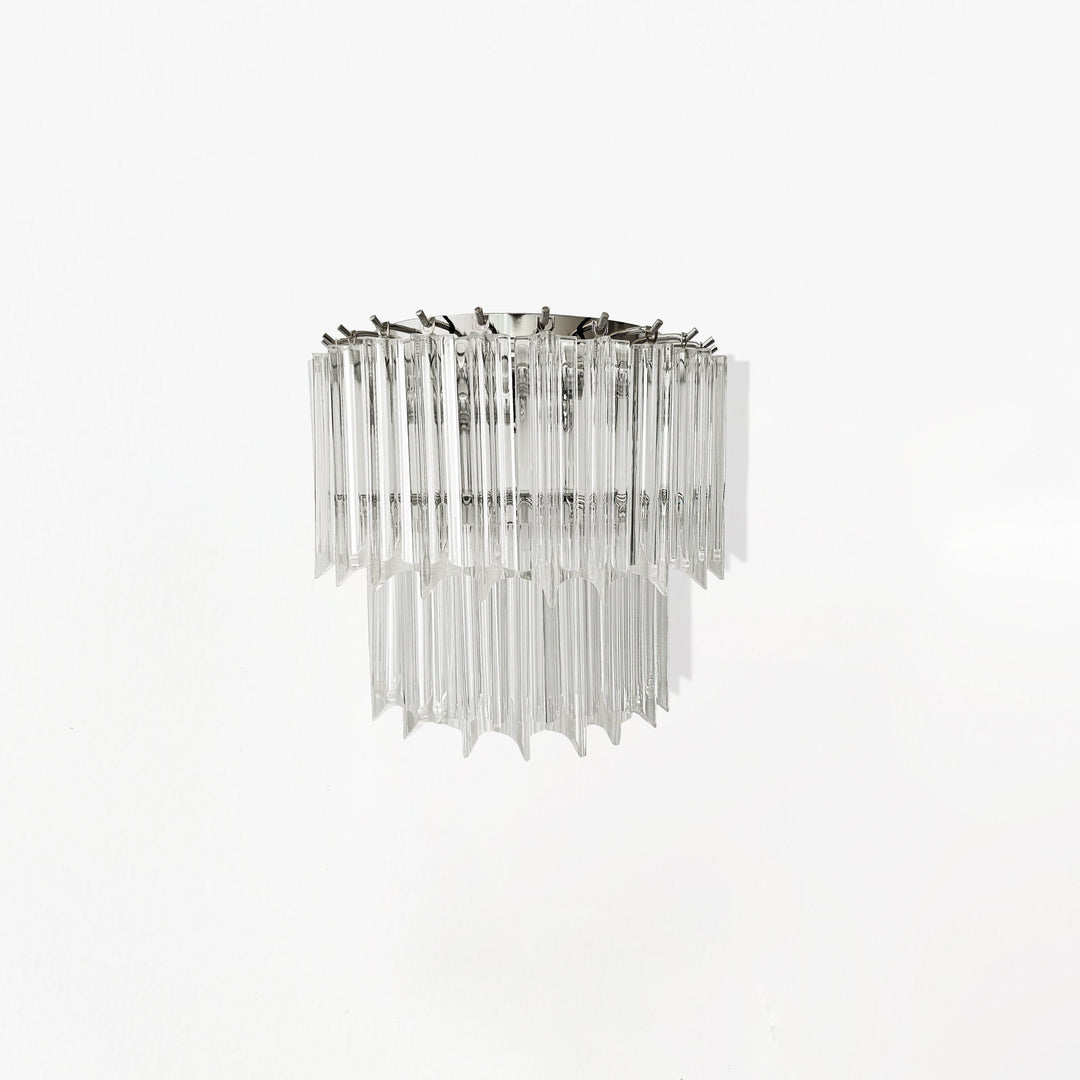 Wall sconce with clear glass and metal frame on a white background