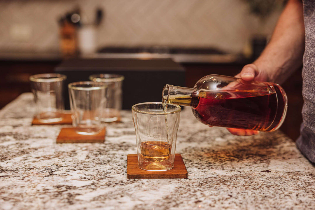 Pouring whiskey into a glass from Old World Whiskey Decanter and Glass Set in Faux Leather Case