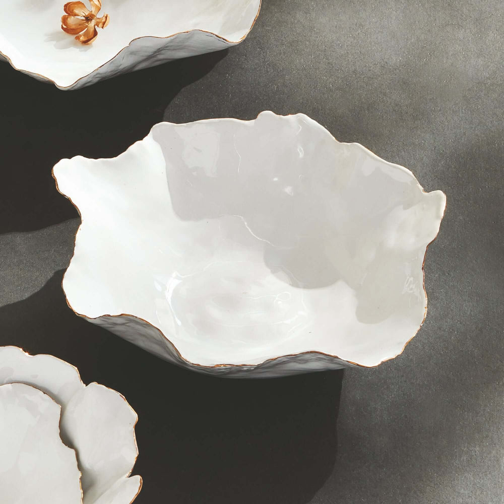 Organic shape decorative ceramic bowl with hand-applied gold trim, evoking the beauty of nature and the allure of imperfection.