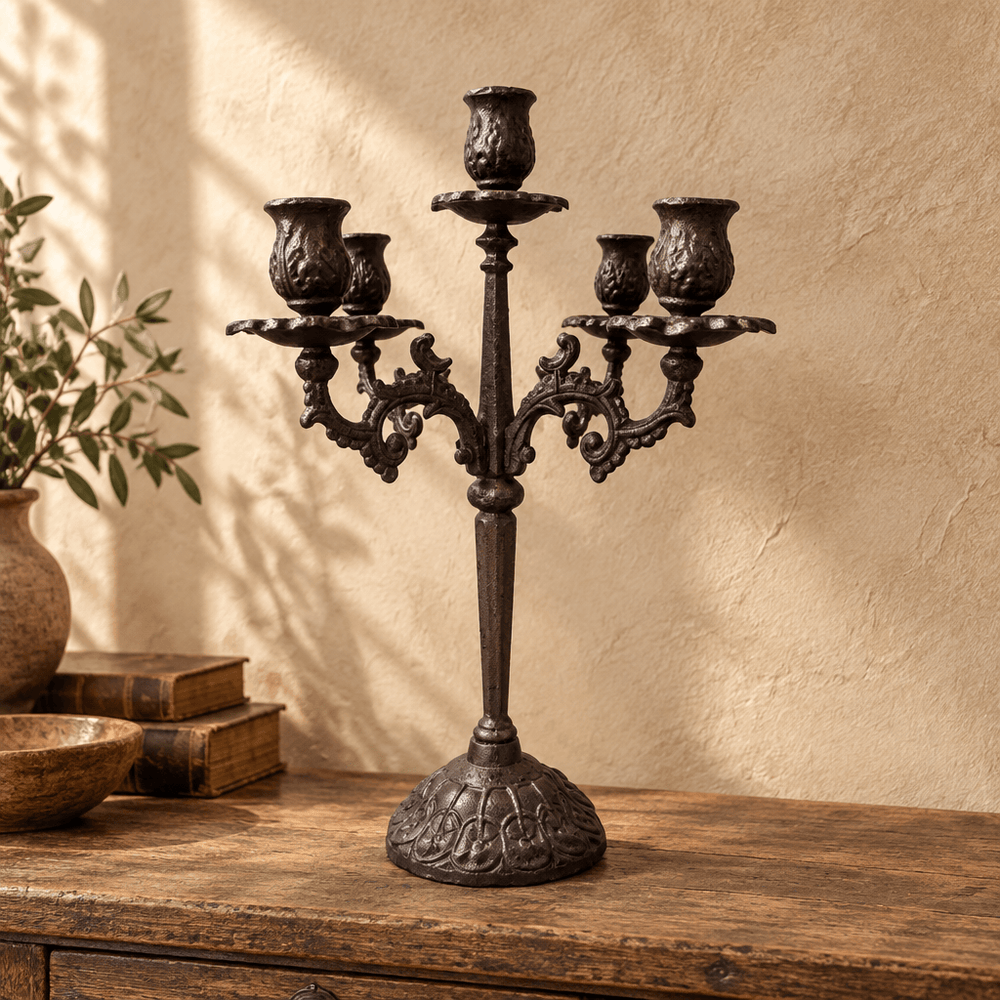 Ornate five-cup cast iron candelabra displayed on a weathered wooden console
