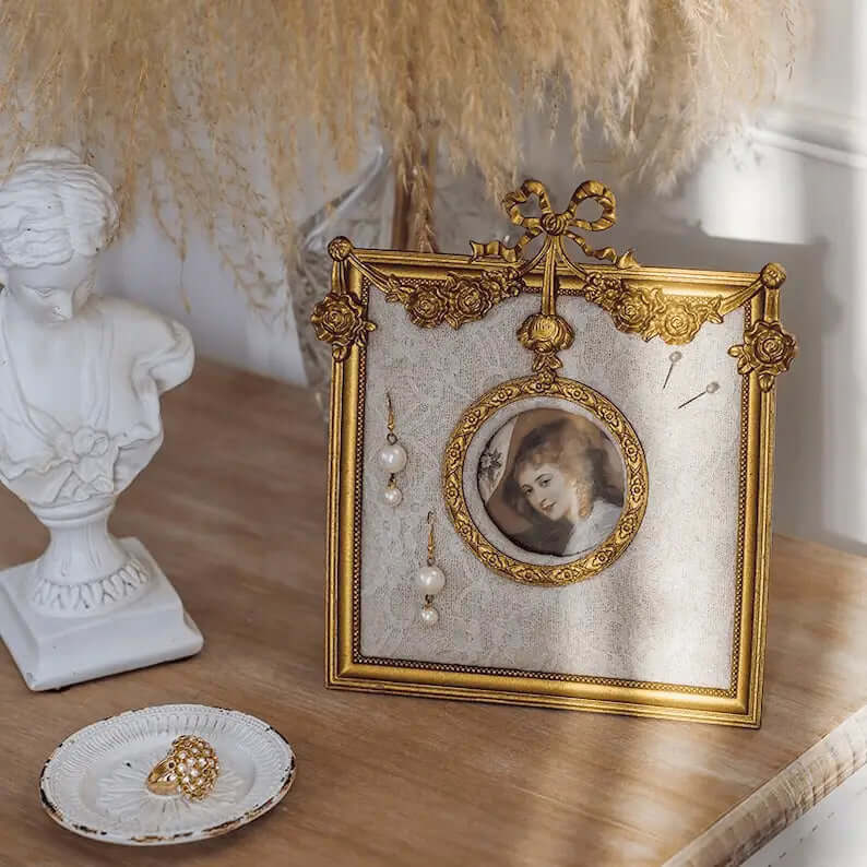 Ornate gold-tone vintage-style earring holder on a vanity