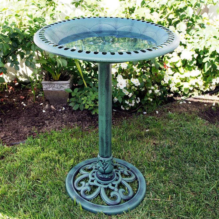 Antique Green Bronze Bird Bath with Pedestal Base in garden setting, highlighting classic design and weathered finish.