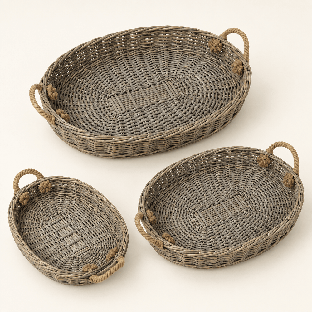 Three graduated oval willow trays with jute handles on an ivory background