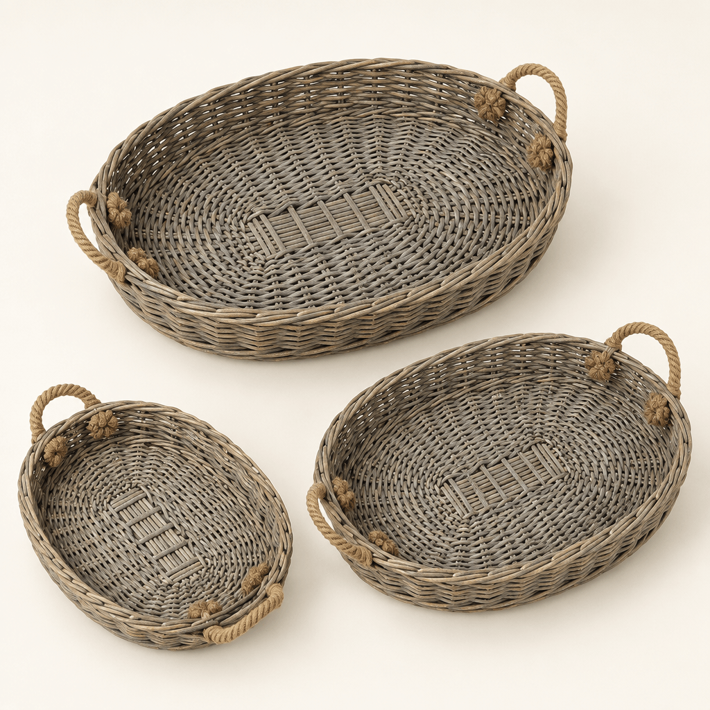 Three graduated oval willow trays with jute handles on an ivory background