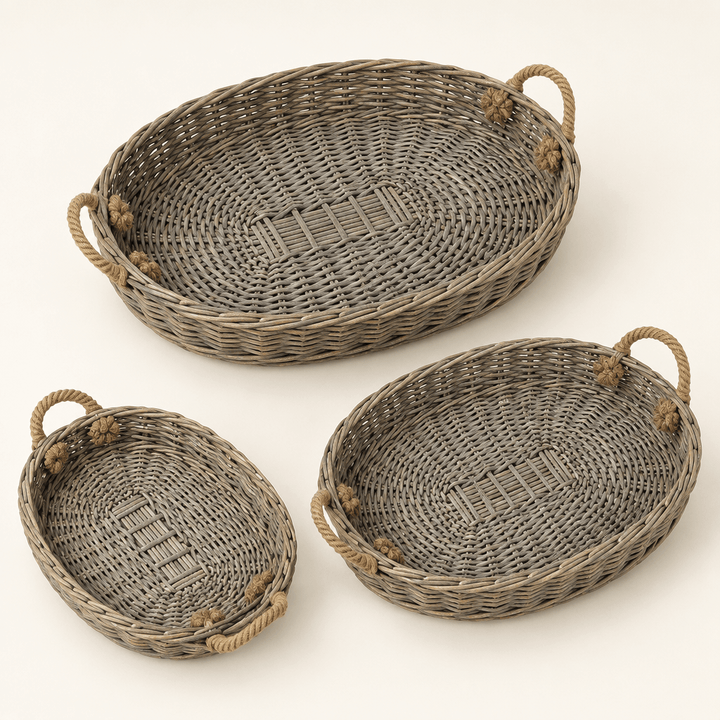 Three graduated oval willow trays with jute handles on an ivory background