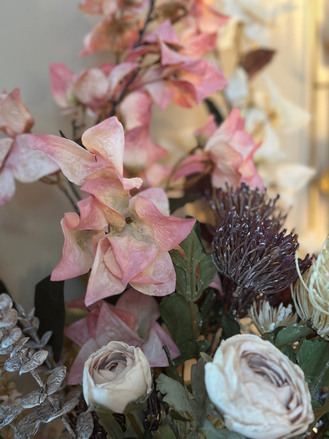 Close view of blush bougainvillea bracts among a romantic mixed bouquet