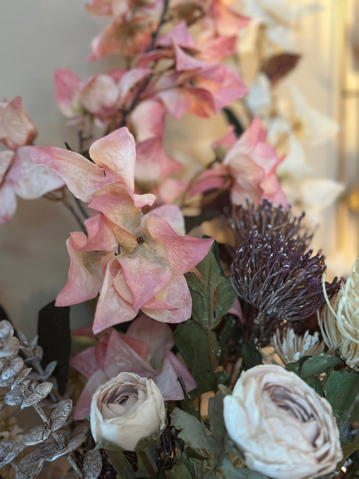 Close view of blush bougainvillea bracts among a romantic mixed bouquet