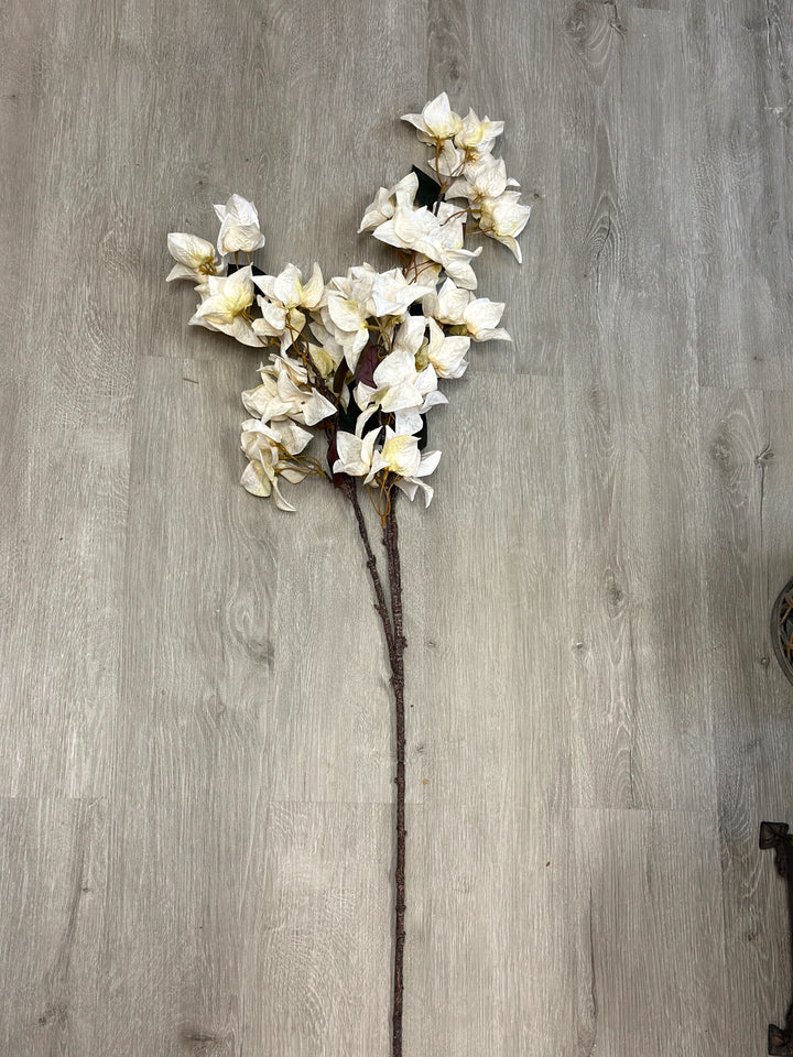 White bougainvillea faux flower stem laid flat to show its natural branching form