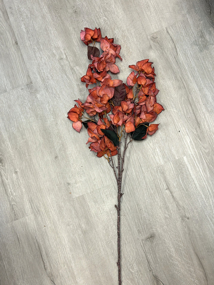 Red bougainvillea faux flower stem laid flat with richly colored bracts