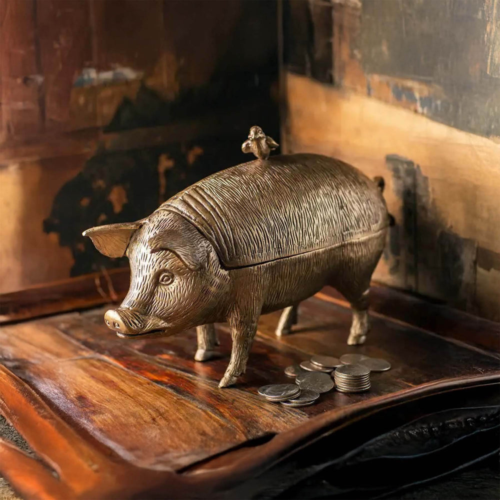 Vintage Brass Pig Storage Box on wooden surface with coins, showcasing detailed craftsmanship and antique finish.