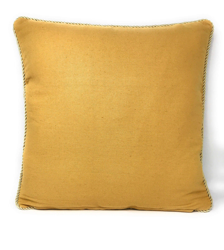Yellow square pillow with a simple design on white background.