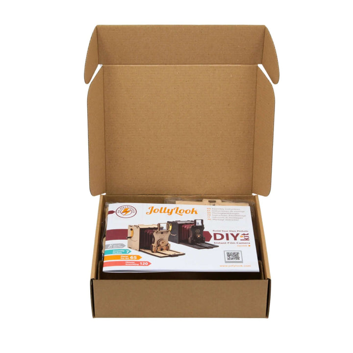 Open box displaying Pinhole Square Instant Film Camera DIY Kit components and guide.