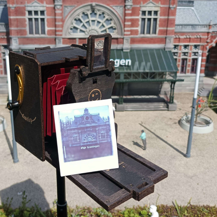 Pinhole Square Instant Film Camera DIY Kit capturing a vintage-style image outdoors with an antique camera design.