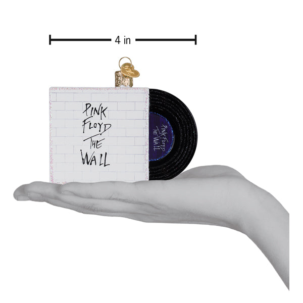 Pink Floyd The Wall Glass Christmas Ornament held in hand, showcasing its design size.