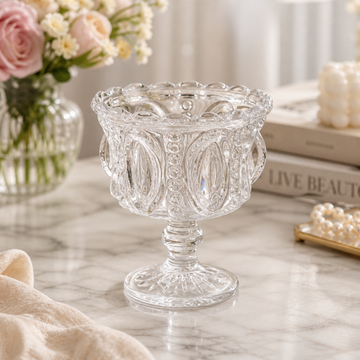 Pressed glass pedestal compote bowl with ornate medallion pattern