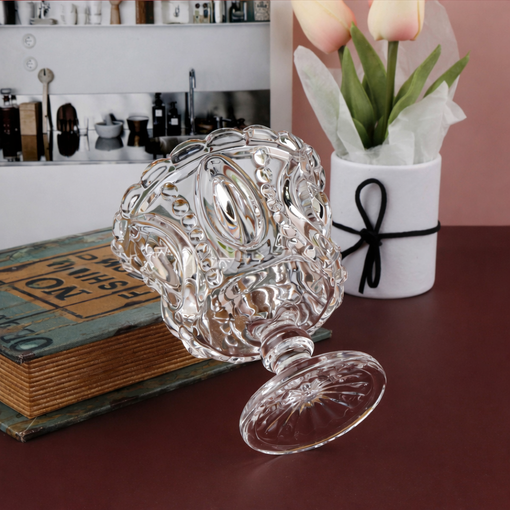 Side view of pressed glass pedestal compote bowl and sunburst foot
