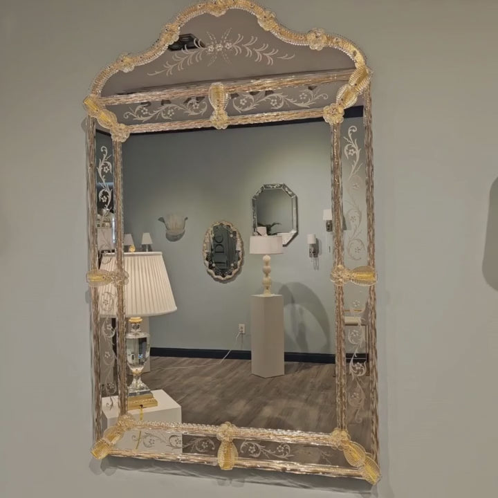 Murano Glass Mirror with Gold Leaf Trim and Etched Panels in display room showcasing Venetian craftsmanship.