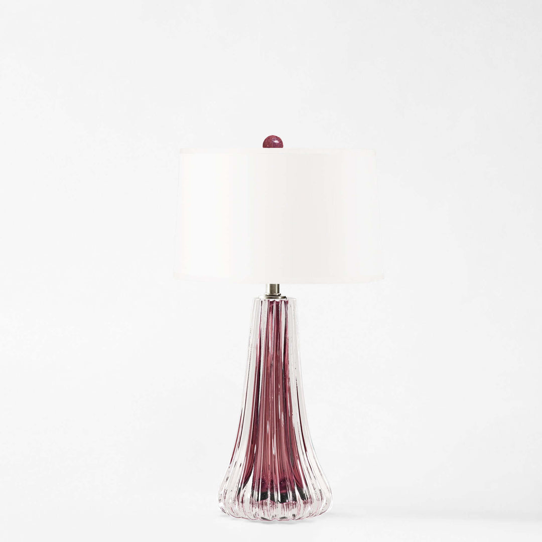 Purple glass table lamp with a metallic cap on a white background