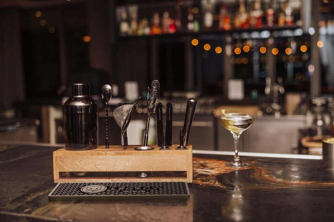 Vintage-Style Bartender Kit with Mango Wood Case & Bar Tools displayed on a bar counter.
