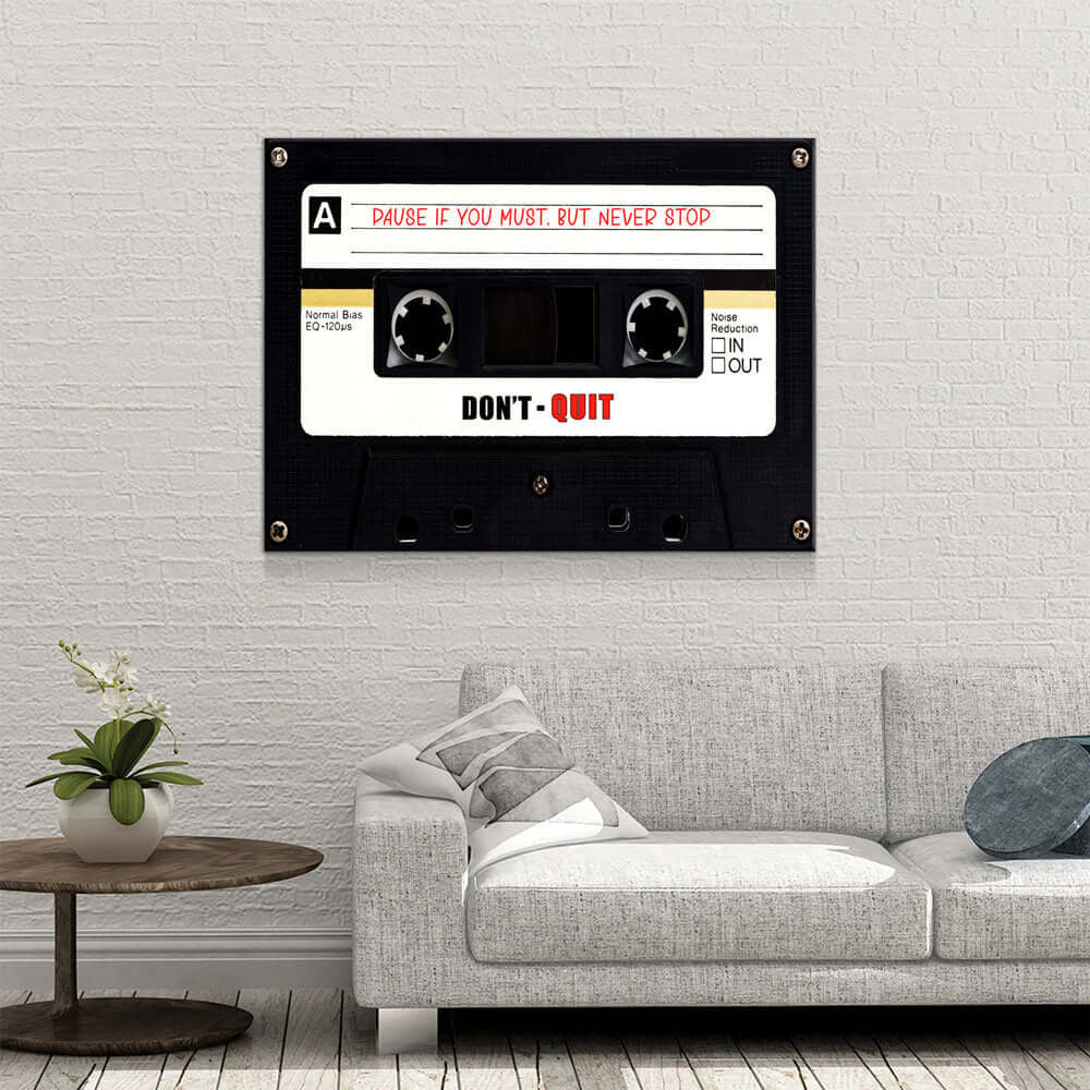 Retro Cassette Tape Motivational Wall Art displayed above a modern sofa, featuring a motivational quote for inspiration and perseverance.