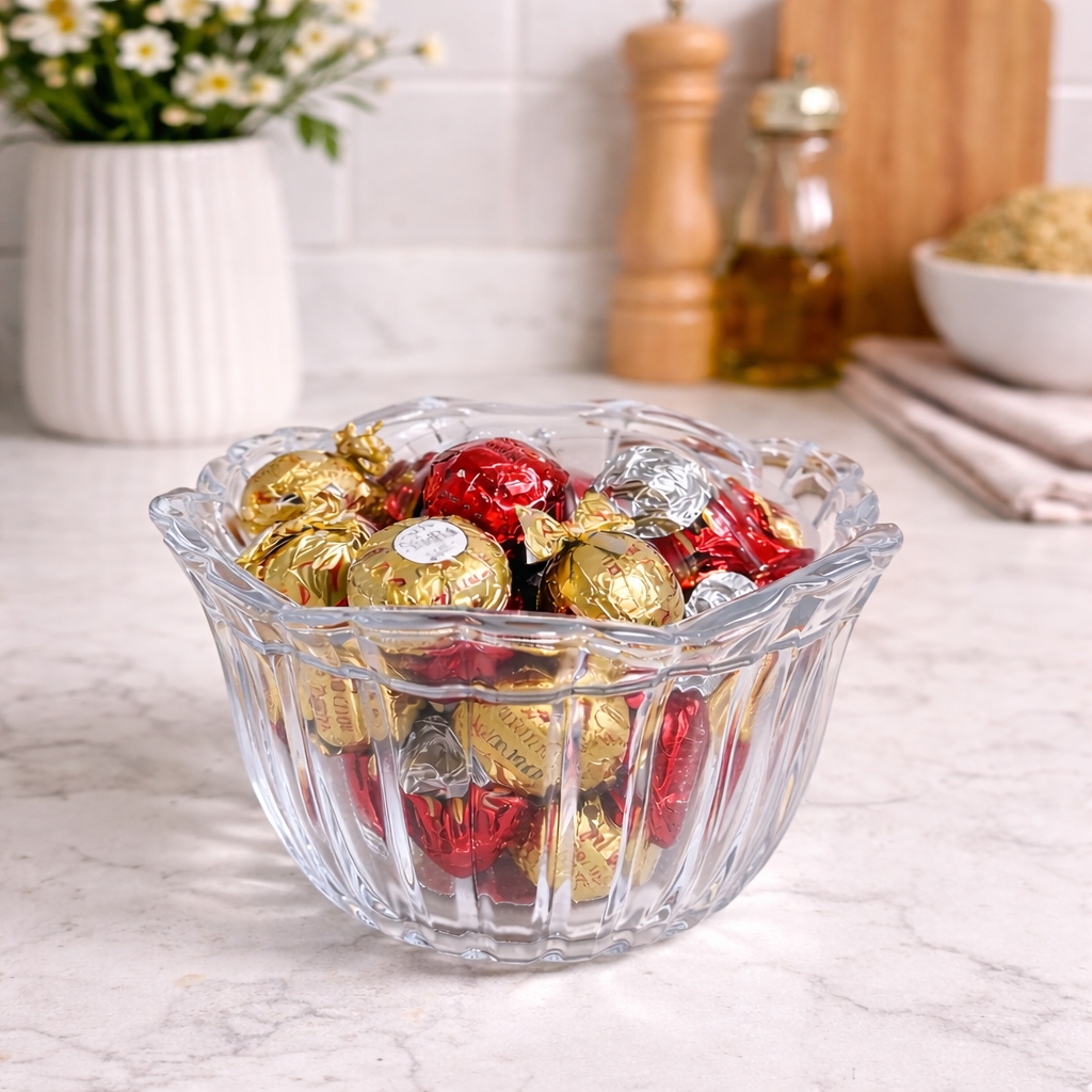 Open ribbed crystal candy dish filled with wrapped chocolates